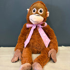 Peluche mono XL sentado con cinta rosada de estrellas