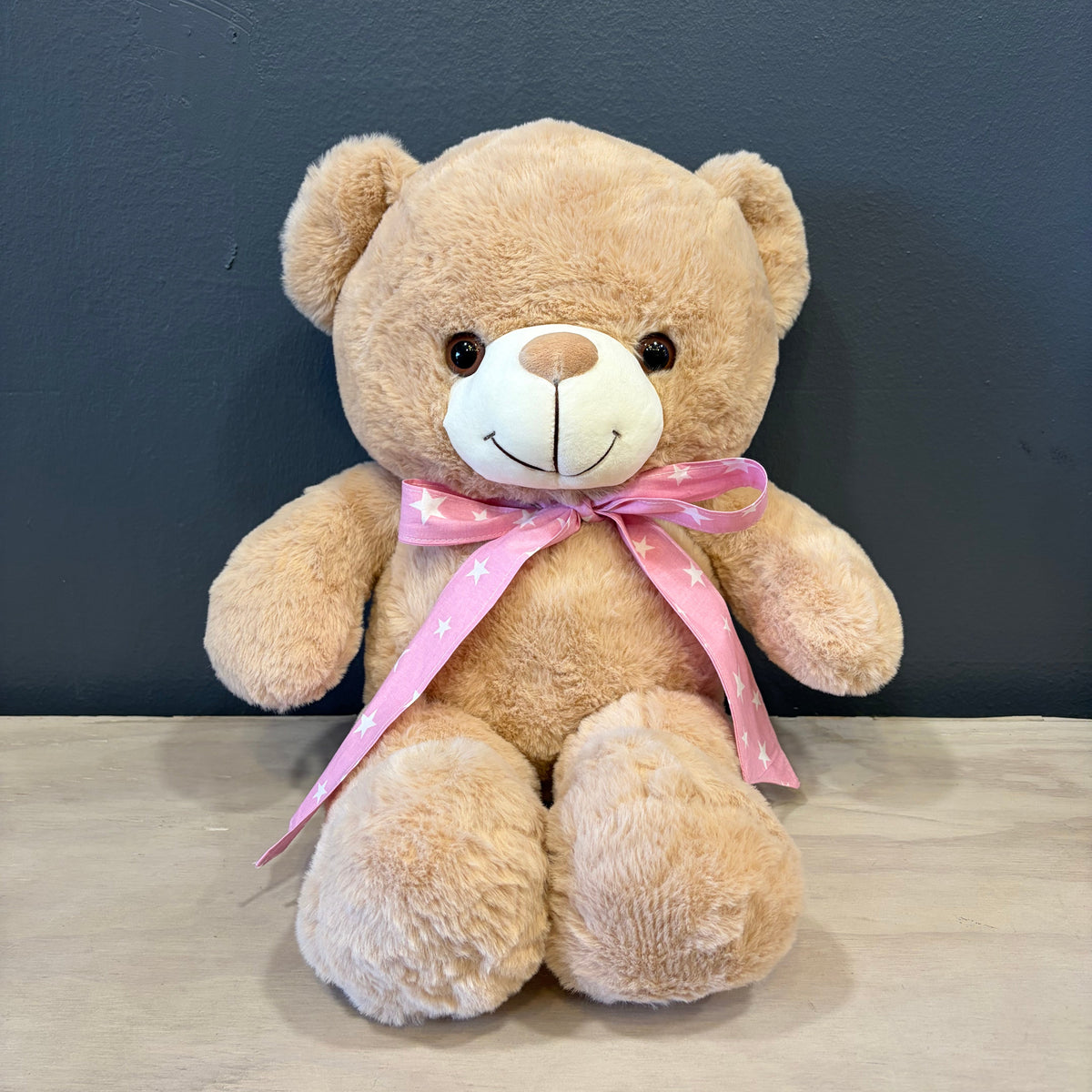 Peluche oso crema XL con cinta rosada de estrellas